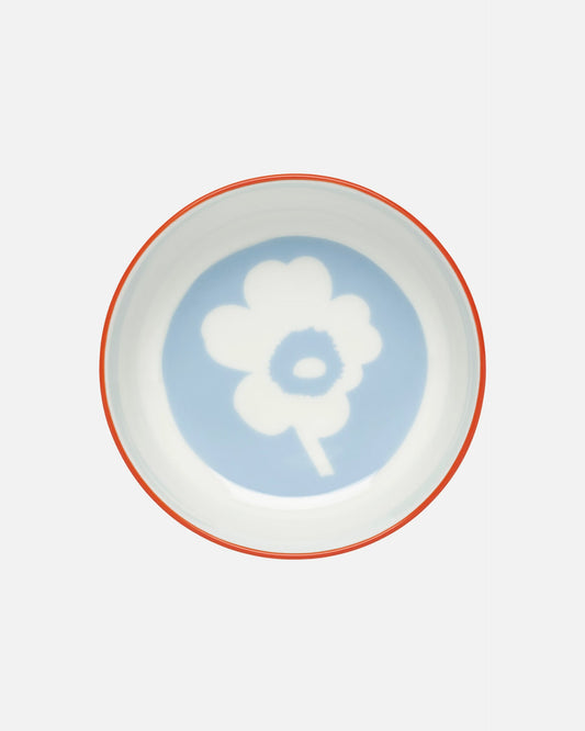 Side-angle view of the Marimekko Oiva 400ml white stoneware bowl featuring the iconic Unikko poppy print in light blue, orange, and red.