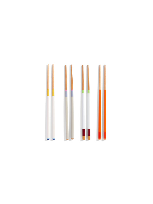Overhead view of four pairs of HAY Colour Sticks crafted from bamboo, showcasing their vibrant, multicoloured lacquered handles arranged on a clean surface.