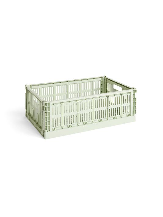 Side-angle view of the large HAY Colour Crate in a fresh mint green, showcasing its high-capacity, stackable, ventilated industrial design made from recycled plastic.
