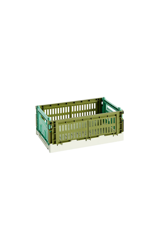 Side-angle view of the small HAY Colour Crate in a two-tone olive and dark mint green, showcasing its stackable, ventilated industrial design made from recycled plastic.