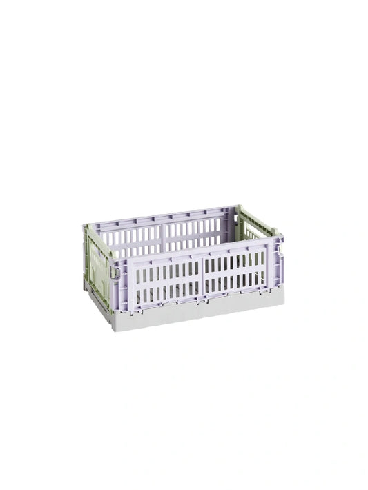 Side-angle view of the small HAY Colour Crate in a soft lavender hue, showcasing its stackable, ventilated industrial design made from recycled plastic.
