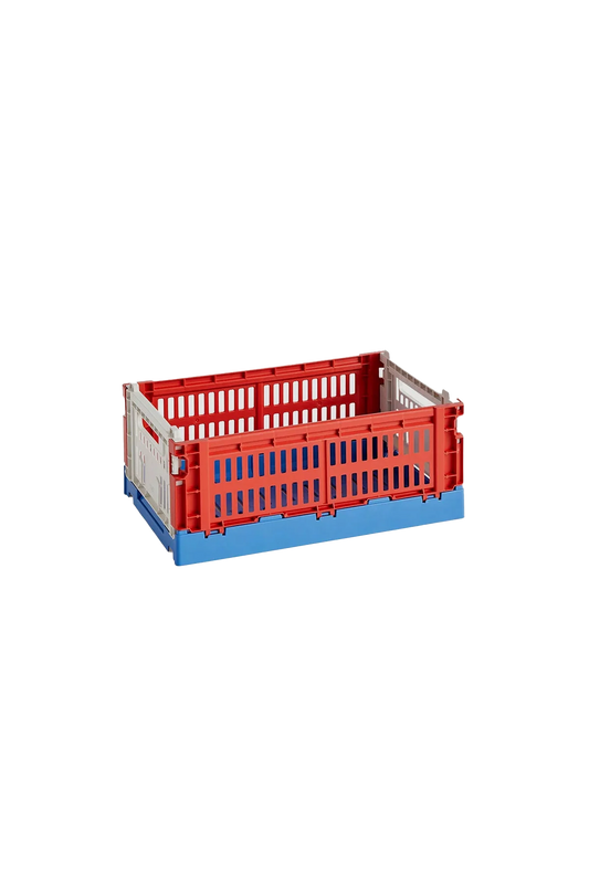 Side-angle view of the small HAY Colour Crate in a vibrant mix red, showcasing its stackable, ventilated industrial design made from recycled plastic.