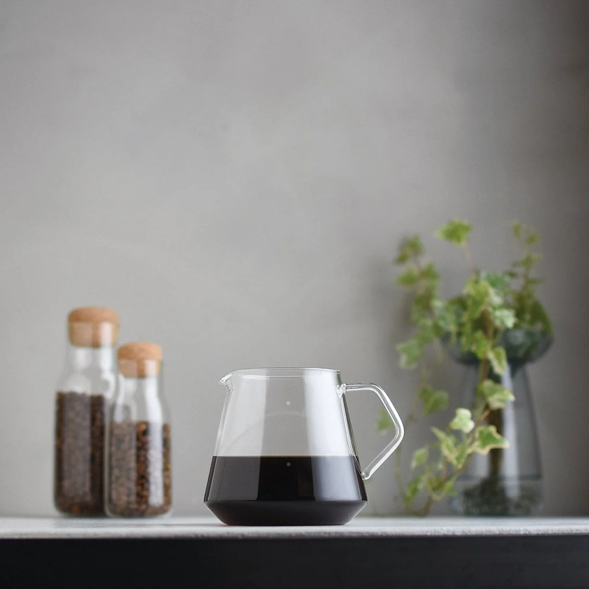 Kinto 600ml glass coffee server brewing filter coffee with dripper on counter