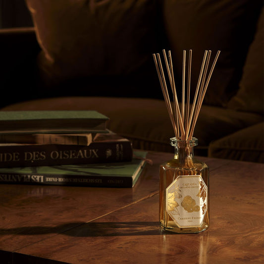 Luxury chestnut scented diffuser on a wooden table, creating a cozy autumn home atmosphere.