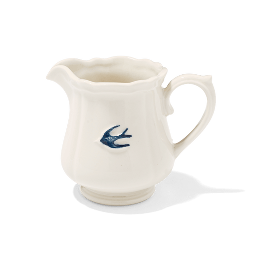 Studio M Early Bird porcelain milk pitcher with blue swallow detail on white background