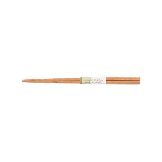 A pack shot of Studio M' Tous Les Jours Chestnut Chopsticks featuring a slim, elegant profile and a distinct, brownish natural wood grain that brings rustic warmth to the table.