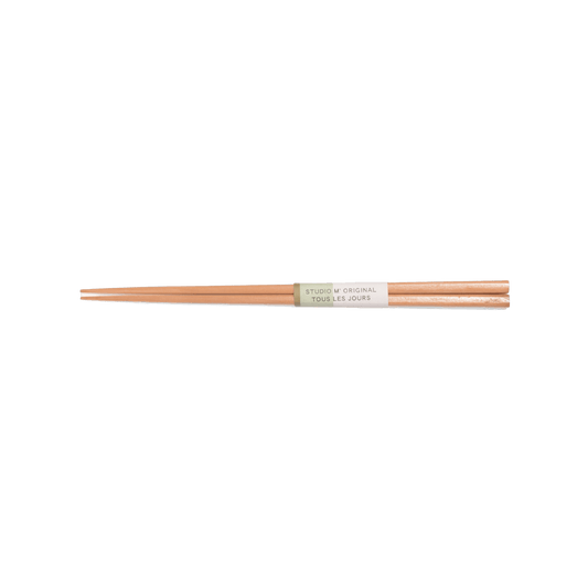 A pack shot of Studio M' Maple Chopsticks 23cm featuring a sleek, slim profile and a smooth, pale blonde natural wood grain that brings light, airy warmth to the table.