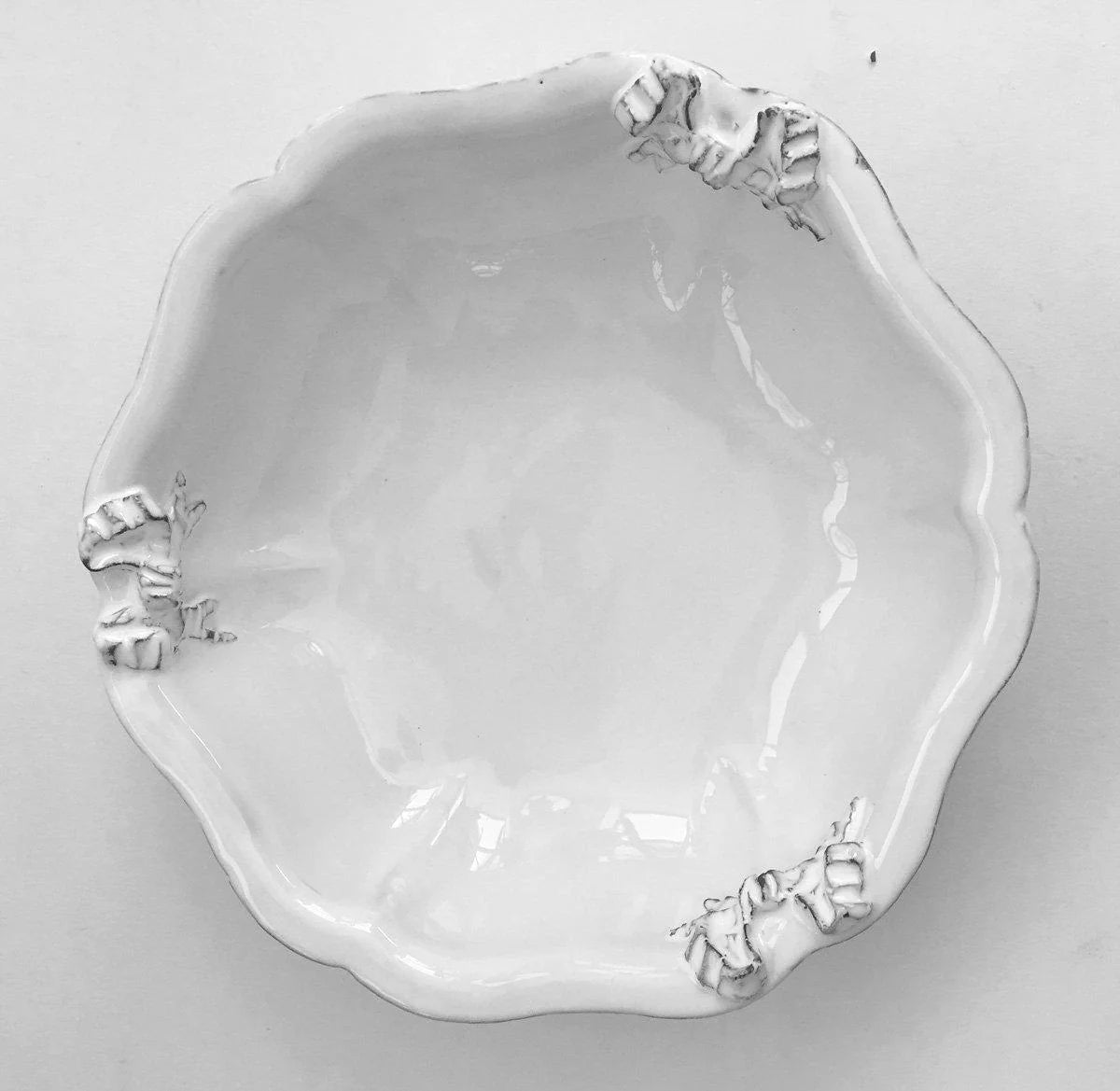 Carron Paris Marie-Antoinette ribbon salad bowl in white enameled terracotta. A shot taken from the high angle.