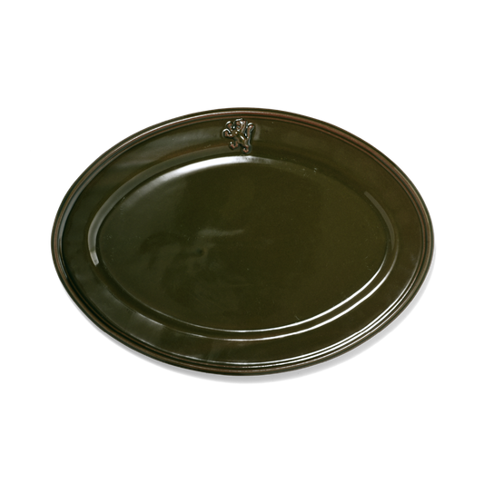 A pack shot of Studio M' Malta Oval Plate 28cm in an earthy green glaze, featuring a sleek, almond-like oval shape and an embossed vintage-style cat crest on the rim.