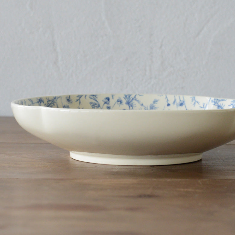 A shot of Studio M' Chamomile Deep Plate from the side angle. 