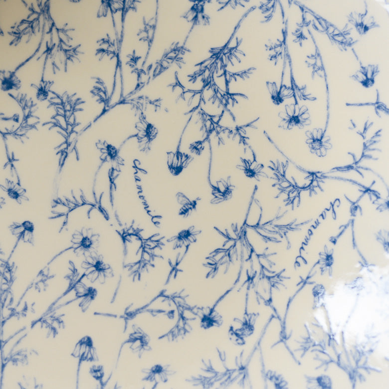 A close-up shot of Studio M' Chamomile Oval Plate, showcasing the details of the floral patterns. 
