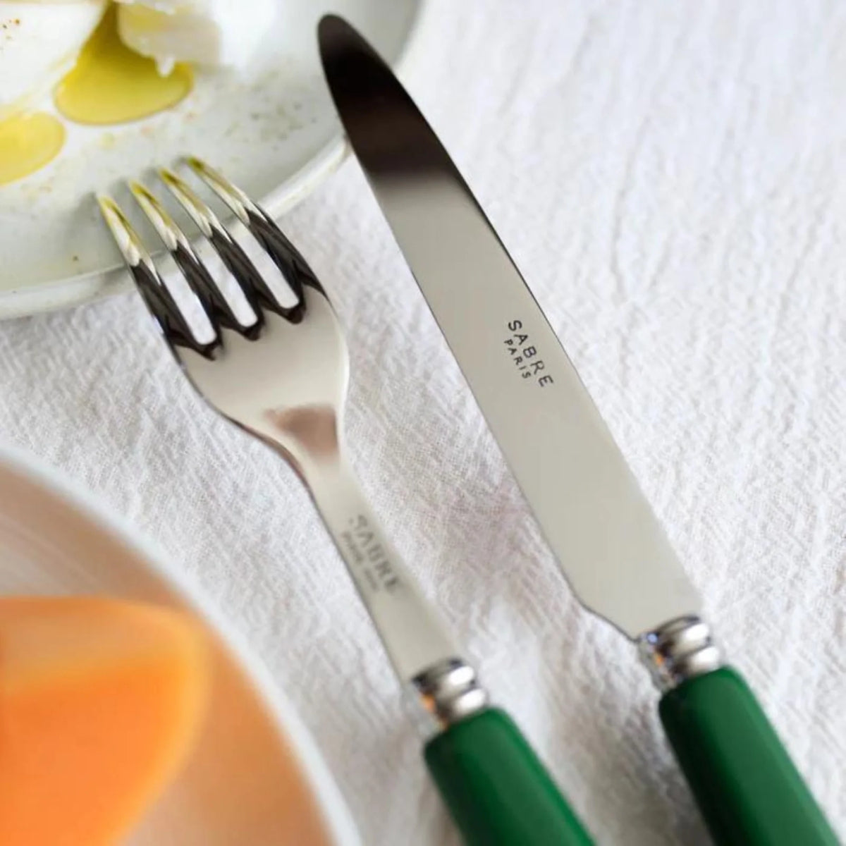 A close-up of Sabre Paris Pop Unis cutlery in green. 