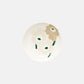 Aerial view of Marimekko Oiva Unikko 16cm stoneware dish in beige sand and dark green