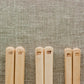 A close up shot of Studio M' Gros Maple Chopsticks 22.5cm featuring Studio M' logo at the end of the chopsticks. 