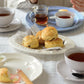 Studio M Creamware Plate L served with fresh fruit scone and butter and jam on a white table cloth. 