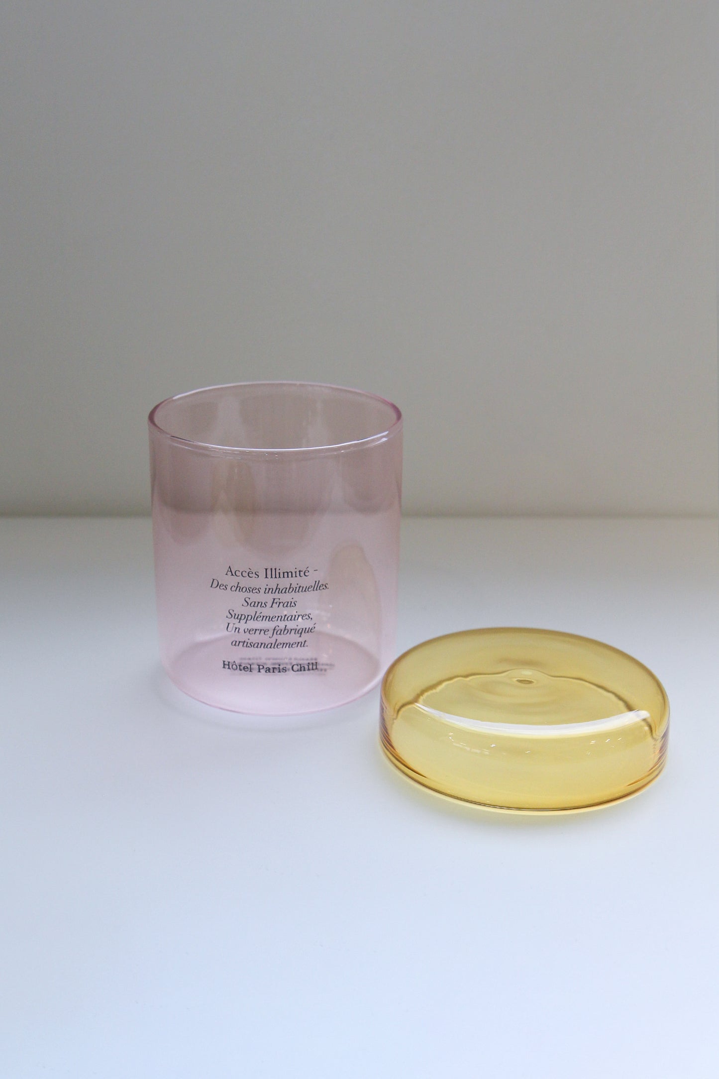 HÔTEL827 pink glass storage jar with lid off.