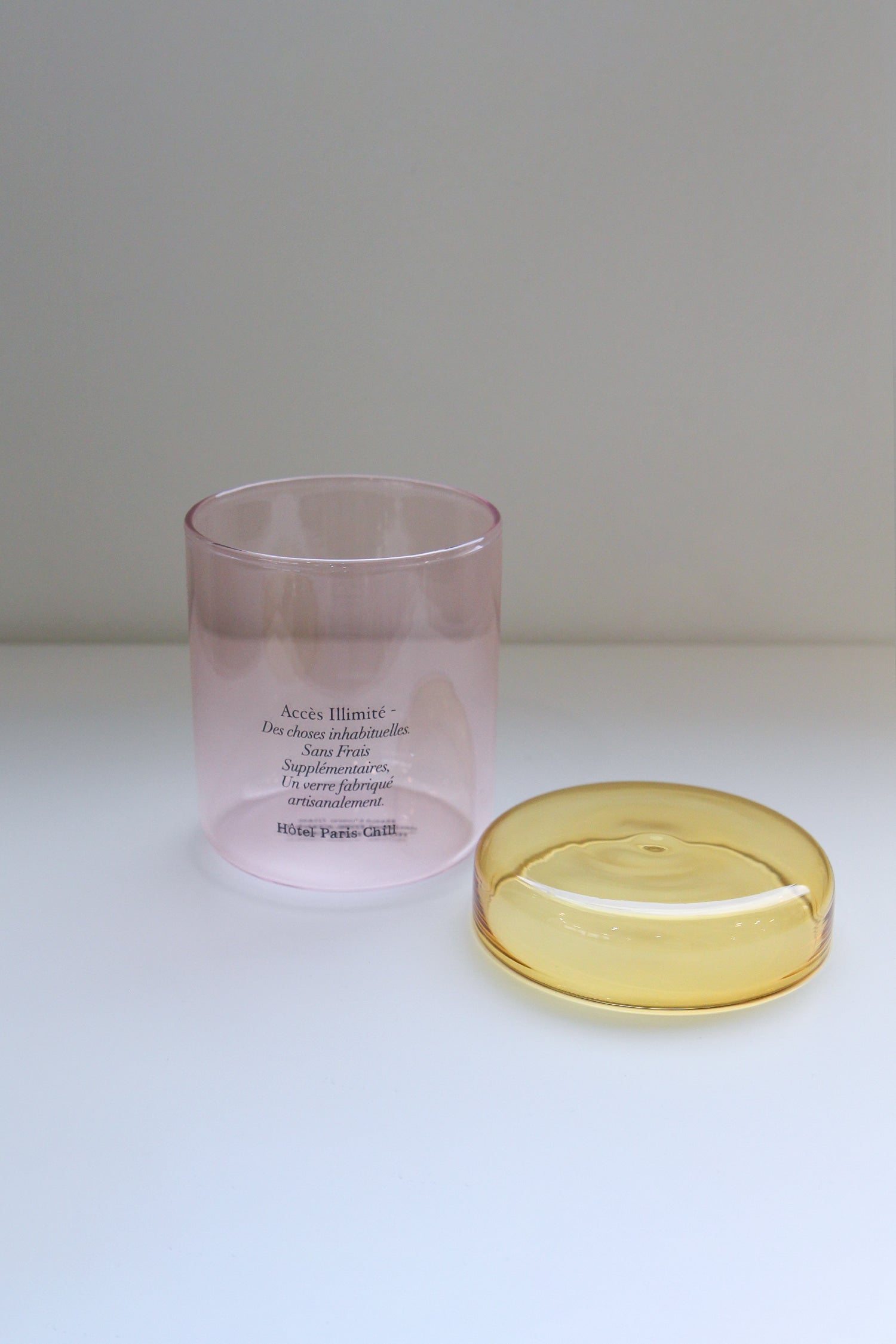 HÔTEL827 pink glass storage jar with lid off.