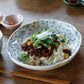 Studio M' Chamomile Deep Plate in lunch table setting, serving a noodle salad. 