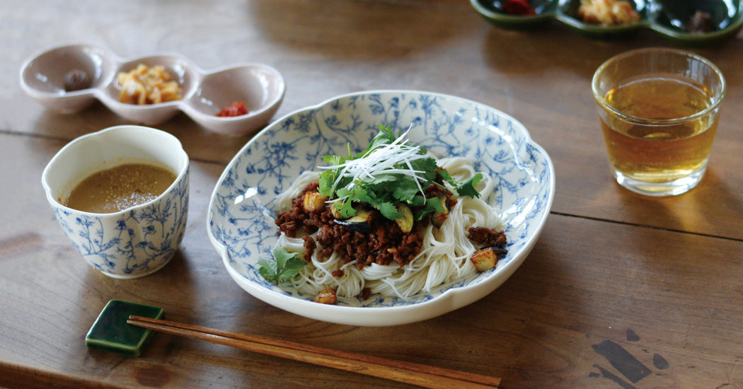 Studio M' Chamomile Deep Plate in lunch table setting, serving a noodle salad. 