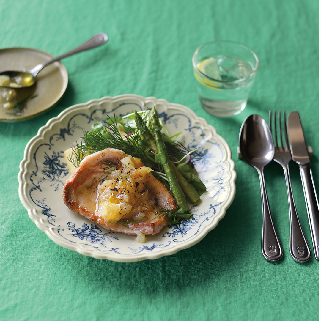 A close-up shot of Studio M' Moment Plate 24cm in a beautiful blue glaze on a table setting.