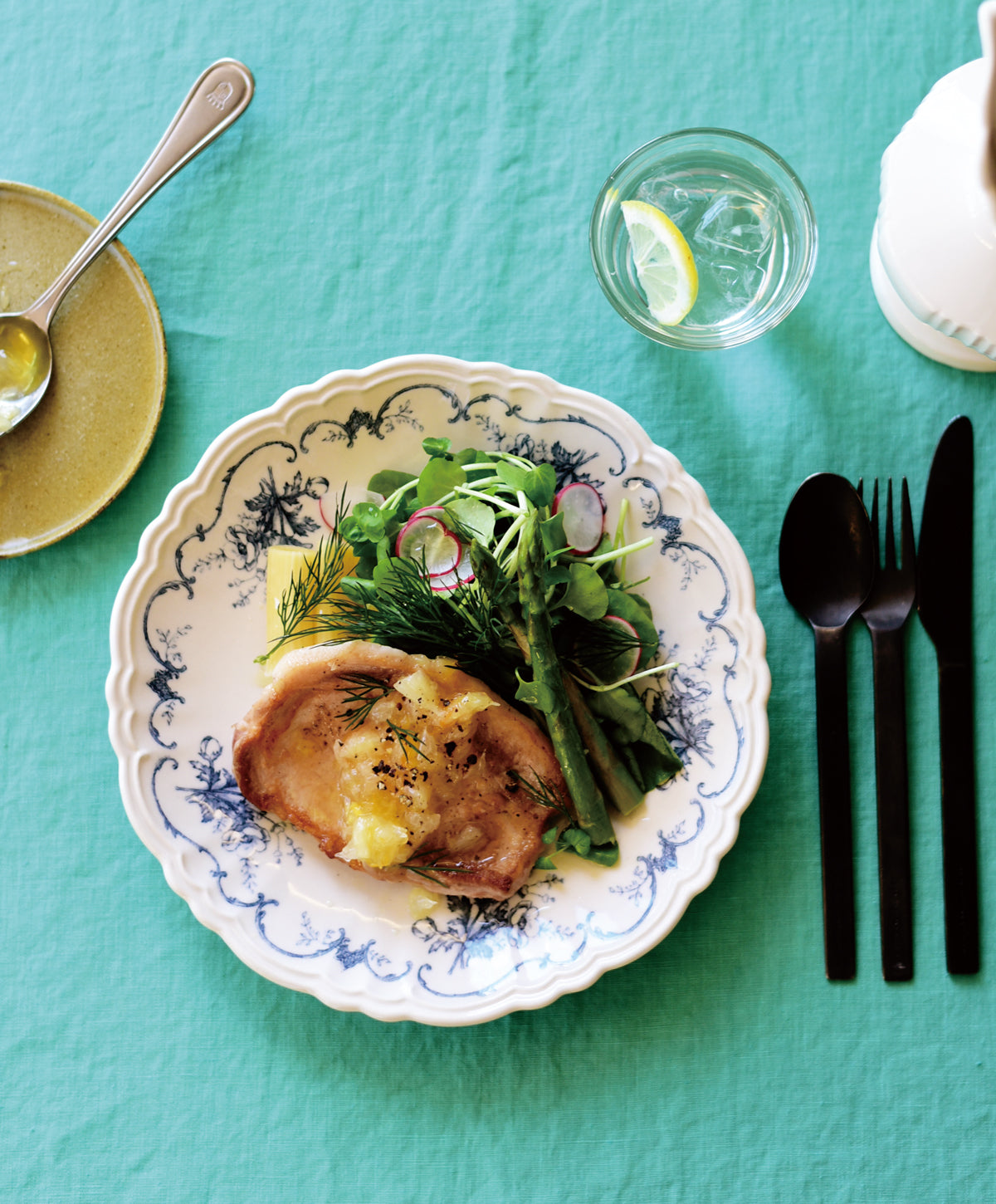 Studio M' Moment Plate 24cm in a beautiful blue glaze, on a table setting. 