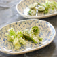 Studio M' Chamomile Oval Plate in white porcelain, featuring a vintage blue floral pattern and a gently curved traditional Japanese Mokkou shape. Serving side dishes. 