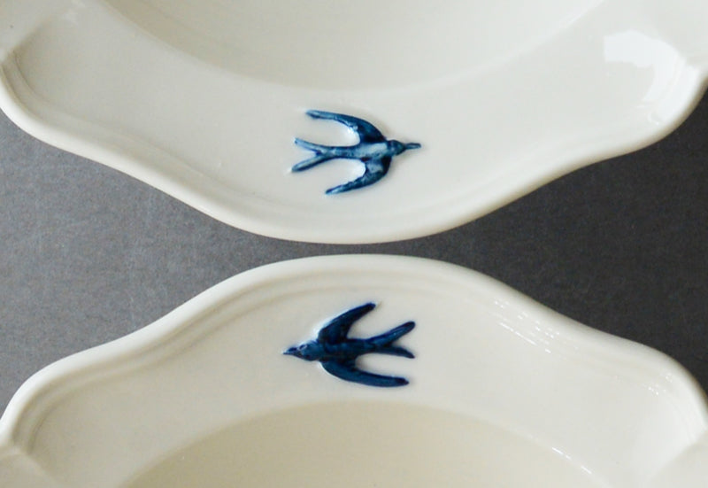 A close up shot of the hand painted bird on the rim of the Studio M' Early Bird Bowl 17cm. 