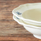 A close-up shot of the rims of stacked Studio M' Early Bird 170 porcelain bowls.