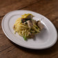 Studio M' Malta Oval Plate 28cm in a stunning white glaze, serving spaghetti at dinner. 