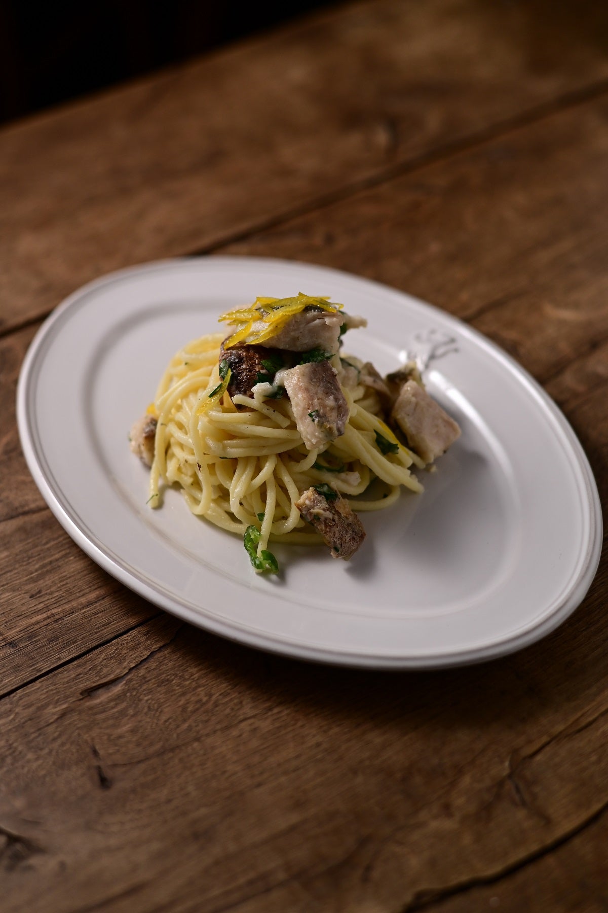 Studio M' Malta Oval Plate 28cm in a stunning white glaze, serving spaghetti at dinner. 