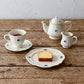 Studio M Early Bird small creamer pared with early bird mug, plates and teapot.