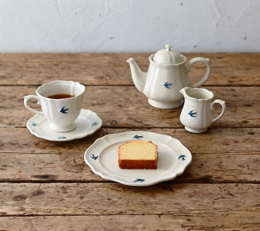 Studio M Early Bird small creamer pared with early bird mug, plates and teapot.