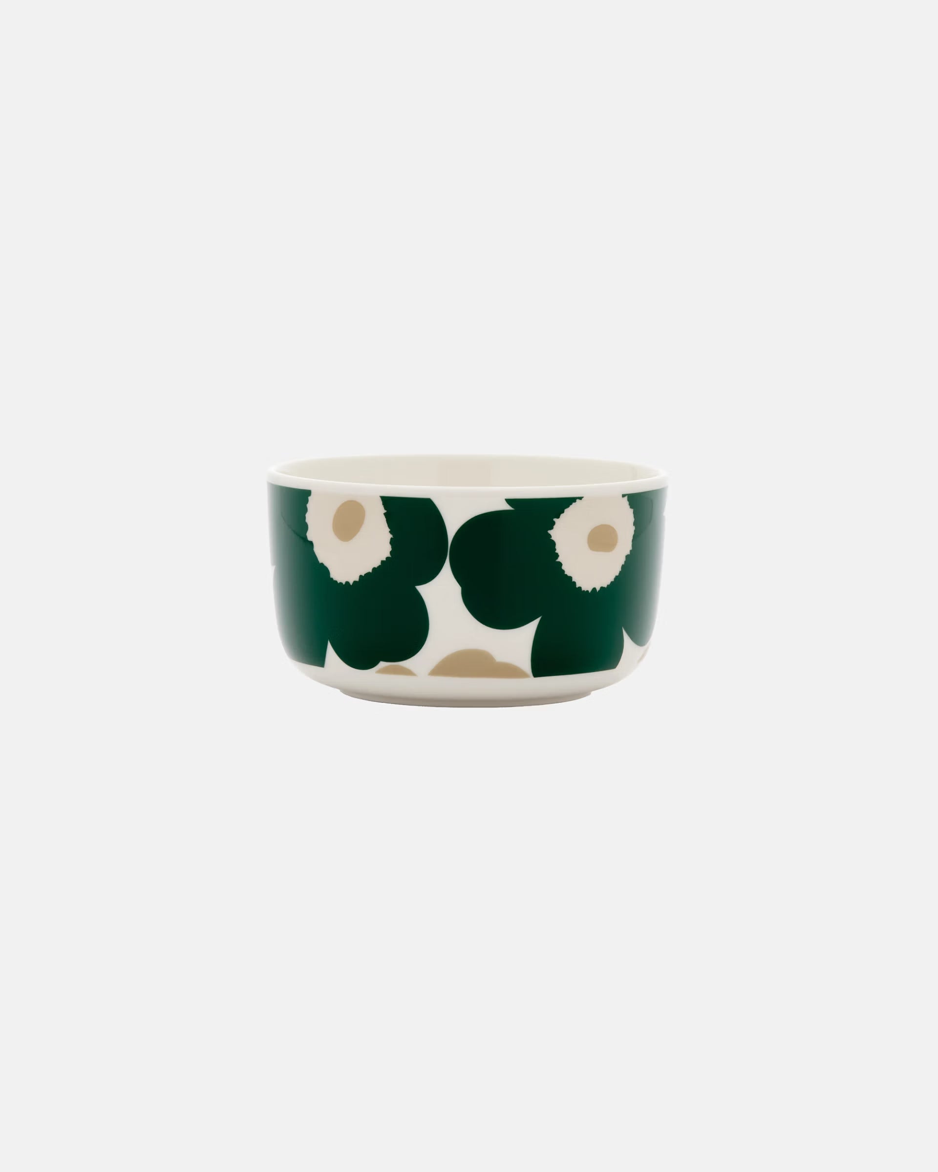 Side-angle view of the Marimekko Oiva 500ml white stoneware bowl featuring the iconic Unikko poppy print in dark green, beige, and light sand.