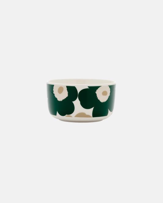 Side-angle view of the Marimekko Oiva 500ml white stoneware bowl featuring the iconic Unikko poppy print in dark green, beige, and light sand.