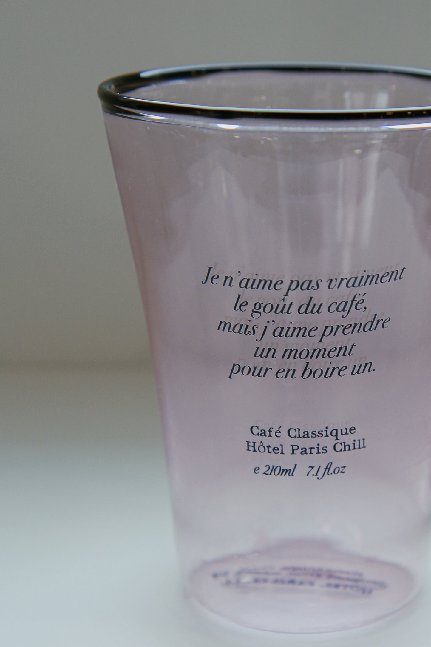 Close-up of mouth-blown organic glass ripples and graphic on HÔTEL827 pink cup