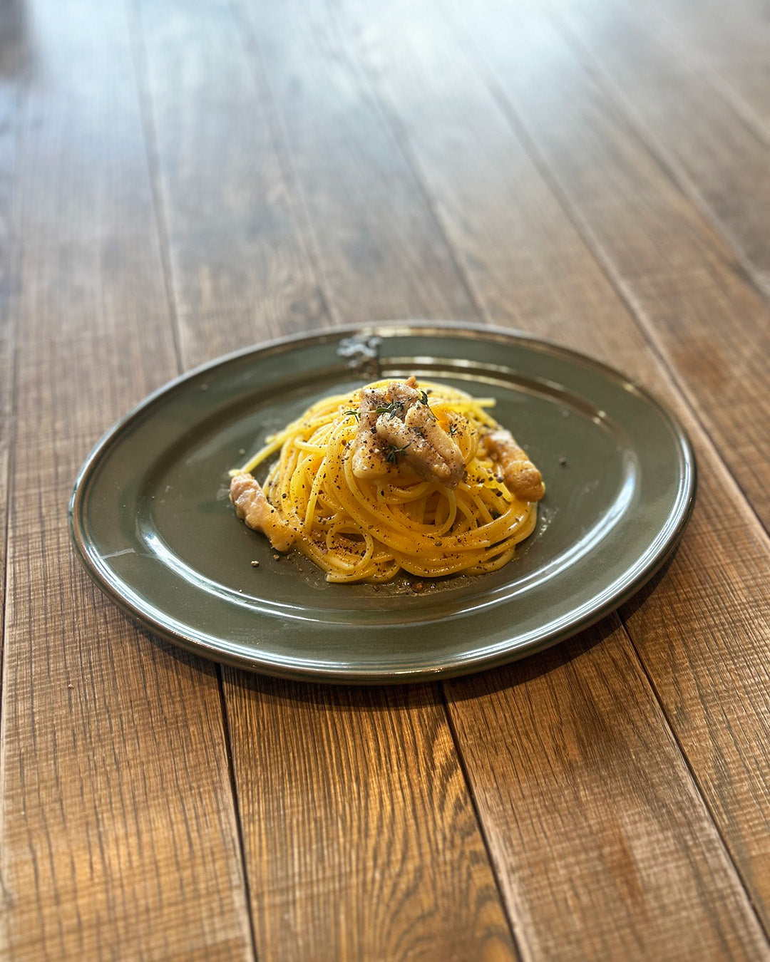 Studio M' Malta Oval Plate 28cm in an earthy green glaze, a perfect plate for serving spaghetti. 