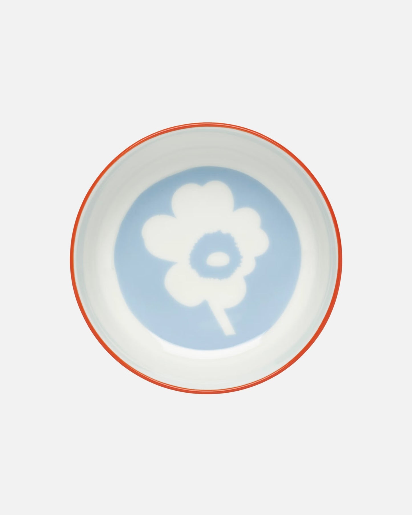 Side-angle view of the Marimekko Oiva 400ml white stoneware bowl featuring the iconic Unikko poppy print in light blue, orange, and red.