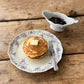 Studio M' Audrey 200 Plate in lavender porcelain, featuring a scalloped lace-like rim and an English garden-inspired floral relief pattern. Used to serve pancakes.