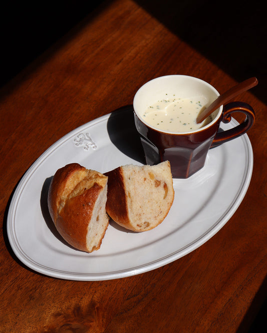 Studio M' Malta Oval Plate 28cm in a stunning white glaze, serving breakfast.