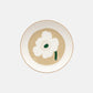 Overhead view of the Marimekko Oiva 20.5cm white stoneware deep plate featuring the iconic Unikko poppy print in dark green, beige, and light sand.