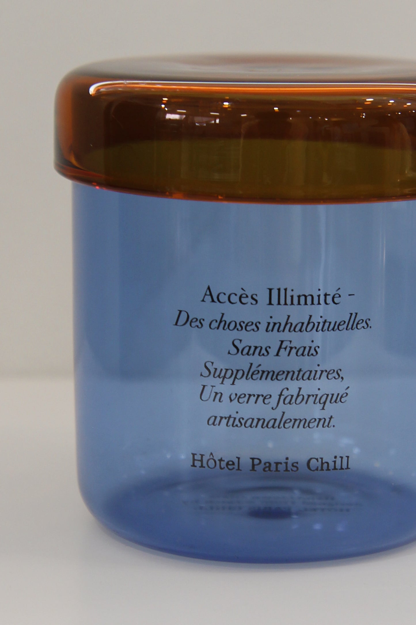 Close-up of HÔTEL827 Overhaze Blue mouth blown borosilicate glass jar container with lid