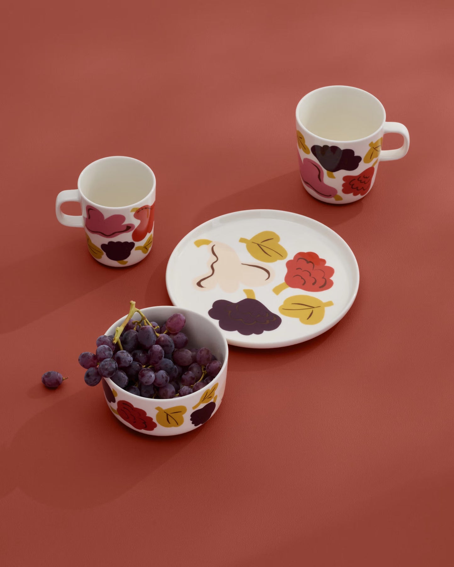 A lifestyle shot of The Meriemko oiva collection with Kukasta Kukkaan abstract floral and leaf patterns. 