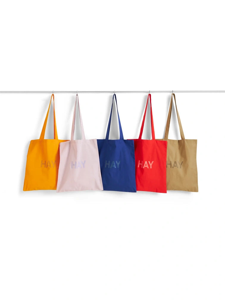 Hay log-print cotton tote bags on the hanger against whit background.