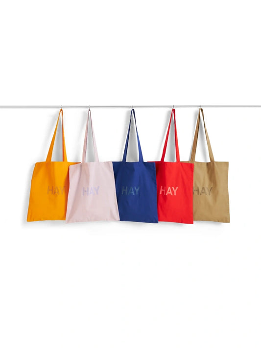 Hay log-print cotton tote bags on the hanger against whit background.