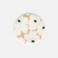Overhead view of the Marimekko Oiva 20cm white stoneware plate featuring the iconic Unikko poppy print in dark green, beige, and light sand.