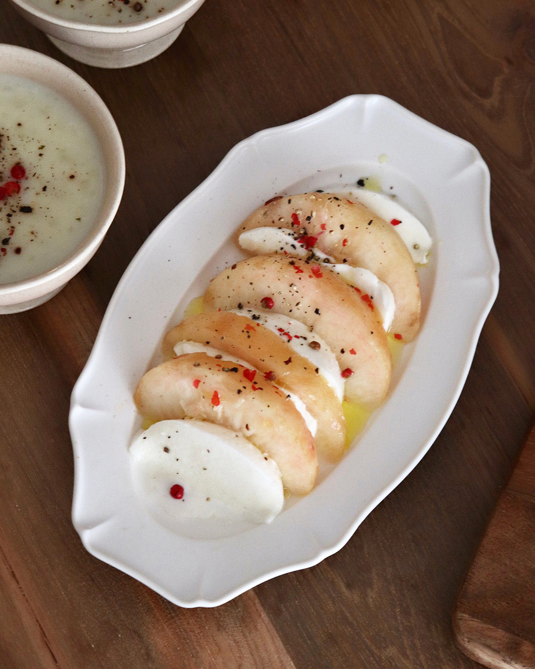 Studio M Ornata matte white 20cm oval plate with afternoon dessert.