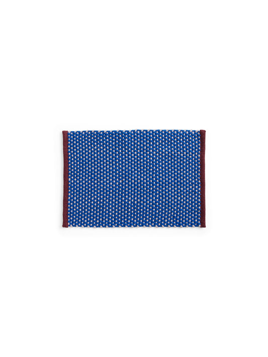 Overhead view of the HAY rectangular door mat in royal blue, showcasing its textured two-tone jute weave and contrasting wool border trim.