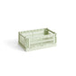 Side-angle view of the small HAY Colour Crate in a fresh mint green, showcasing its stackable, ventilated industrial design made from recycled plastic.
