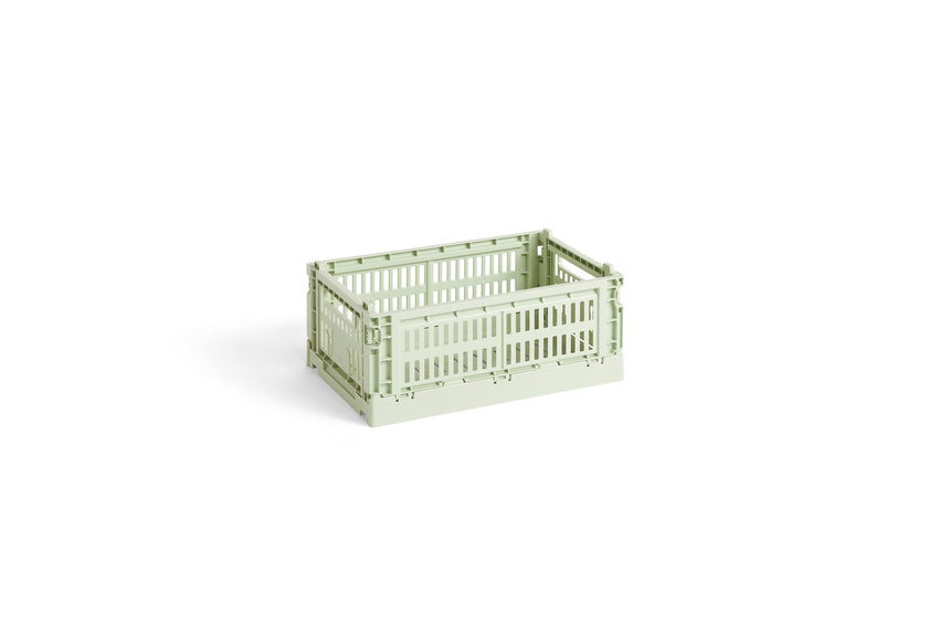 Side-angle view of the small HAY Colour Crate in a fresh mint green, showcasing its stackable, ventilated industrial design made from recycled plastic.