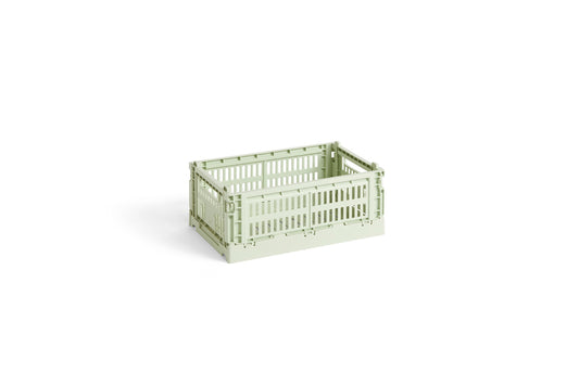 Side-angle view of the small HAY Colour Crate in a fresh mint green, showcasing its stackable, ventilated industrial design made from recycled plastic.